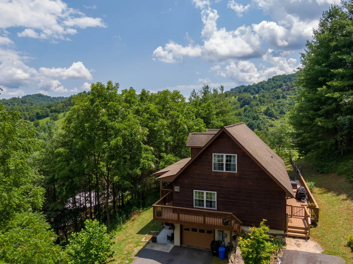 The hero image showcases a charming wooden cabin set amid lush greenery, with a spacious deck perfect for relaxing and taking in tranquil sunset views. The scene exudes peace and privacy, highlighting the inviting outdoor living space ideal for morning coffee, evening barbecues, and quality time with loved ones.
